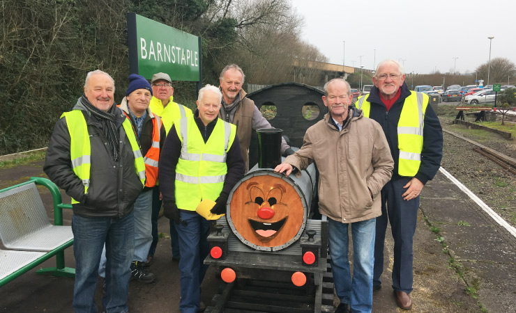 Mens Sheds Torrington group pose with the train model